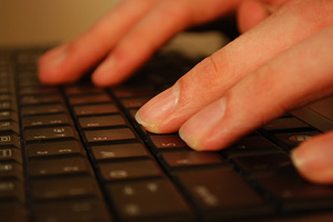 fingers on computer keyboard