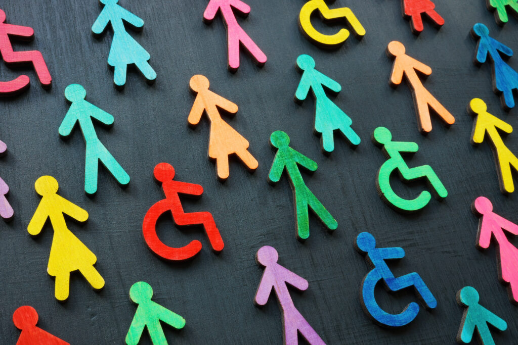 Colorful figurines of men, women and person in wheelchair