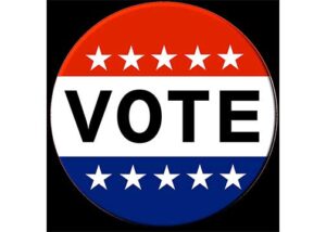 Red, white and blue circle with stars and says Vote in the middle