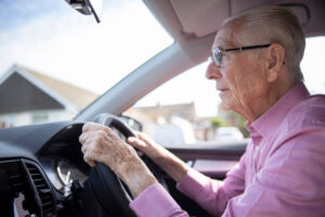 Elderly man driving a car